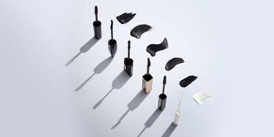 Mascara tubes with mascara brushes which are curved, oversized and comb wands