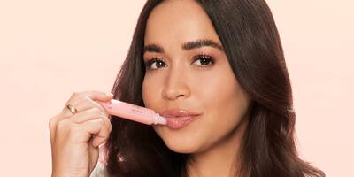 Woman applying juicy tubes lipgloss.