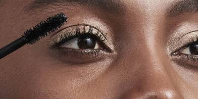Woman applying mascara for a false lash look