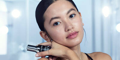 Young woman with a face serum to help with premature aging